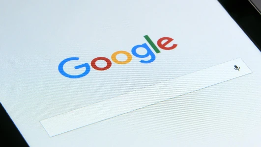 Close-up of a tablet displaying Google's search screen, emphasizing technology and internet browsing.