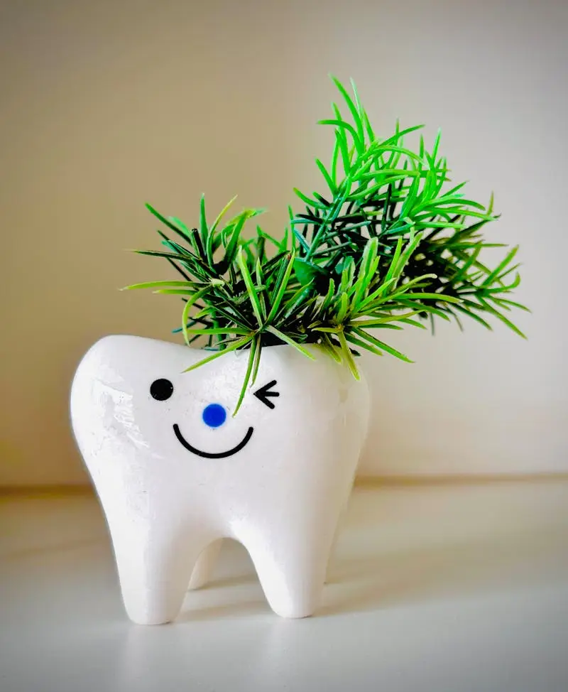 Adorable tooth-shaped planter with vibrant green leaves, perfect for brightening any room.